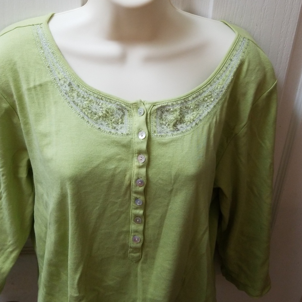 Check out the beadwork on this green shirt